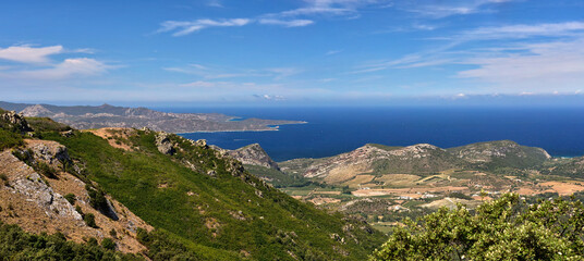 Fototapeta na wymiar Panorama from Col de Teghime, green hills and Mediterranean sea in the background, Landscape od Cap Corse in Corsica