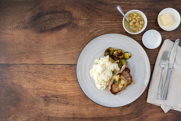 Plate of Pork Chops with Apples and Brussel Sprouts