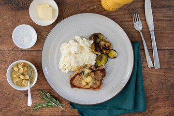 Plate of Pork Chops with Apples and Brussel Sprouts