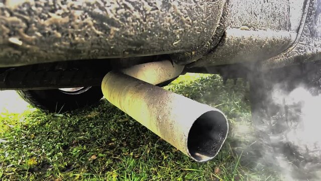 Smoke emissions from Car exhaust pipe, clog air pollution. Toxic fumes of engine car. Combustion gases out of the exhaust pipe of a car. Air pollution from exhaust pipe. Emission Pollution and Co2.
