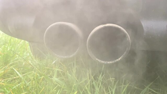 Smoke emissions from Car exhaust pipe, clog air pollution. Toxic fumes of engine car. Combustion gases out of the exhaust pipe of a car. Air pollution from exhaust pipe. Emission Pollution and Co2.