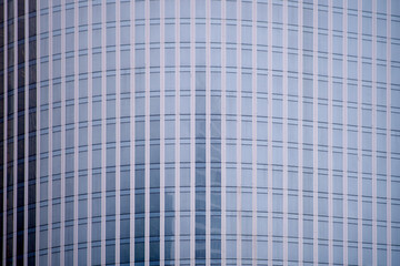 Glass windows of the skyscraper background, copy space. Metal structures with windows of a high-rise building, close-up