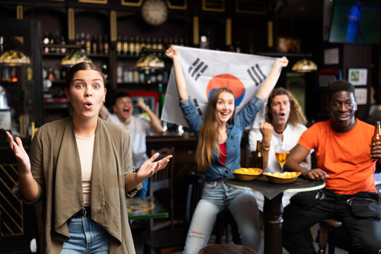 Group Of Happy Friends With Flag Of South Korea Celebrating Victory Of Their Favorite Team In A Beer Bar