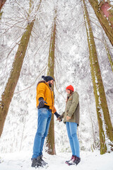 Couple relaxing outdoors on snowy winter day