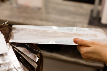 hairdresser coloring client woman hair in beauty barber studio salon,professional dye concept