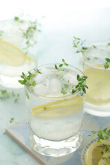 Glasses with lemon and thyme refreshing drink	