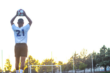 brown skinned soccer player in field throws in foot ball in the field © Ivi - Powerlightss