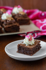 Fototapeta na wymiar Homemade Brownies Decorated for Valentines Day with Sprinkles and Pecans