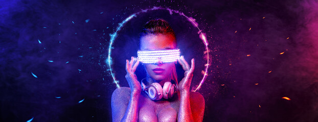 Cyber monday concept. Hot girl DJ in neon lights with headphones. Sexy TDJ at night club party....
