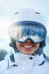 Close Up Of The Ski Goggles Of A Woman With The Reflection Of Snowed Mountains. A Mountain Range Reflected In The Ski Mask. Winter Sports