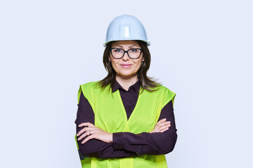 Female industrial construction worker in hardhat vest on white background