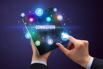 Businessman holding a foldable smartphone