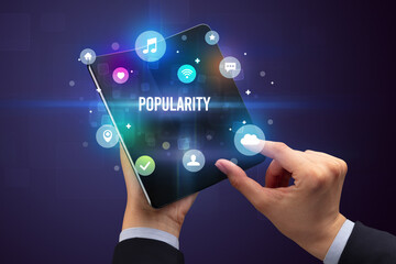 Businessman holding a foldable smartphone