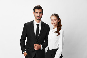 Man and woman smile with teeth business in business attire looking into camera on white isolated background. Stylish business concept paired between employees startup copy space