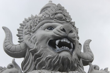 Close up of a lion statue at the gates of Penglipuran village, Bali, Indonesia