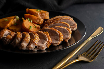 Christmas Roast duck with sweet potato on dark background