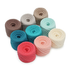 Spools of multi-colored cotton threads on a white background. Cotton yarn in ball and bobbins