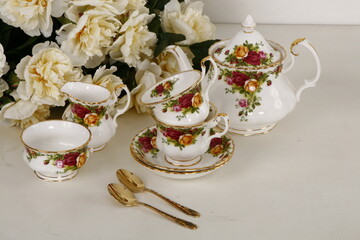 porcelain tea set collection with golden spoons