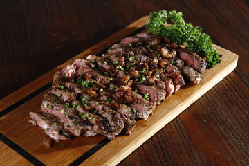 Chopped rib-eye steak on a wooden board