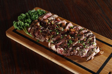 Chopped rib-eye steak on a wooden board