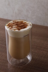 Caramel cappuccino with frothed milk sprinkled with chocolate