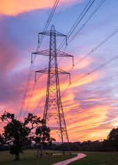 Electrical power lines and towers at sunset.