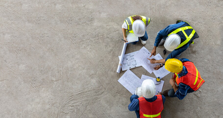 Top view of engineer, architect, contractor and foreman meeting at the construction building site...
