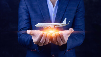 Businessman holding a airplane. Organization of flight traffic. Business and transport, air...
