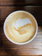 Cup of cappuccino on wooden table
