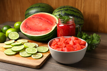 Tasty watermelon drink with lime and fresh ingredients on wooden table