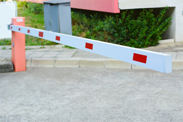 Closed boom barrier on autumn day outdoors