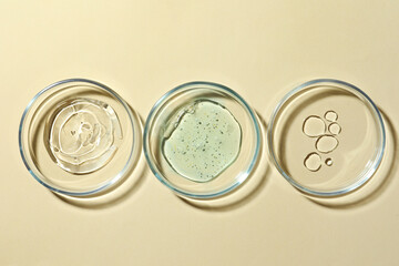 Many Petri dishes and cosmetic products on beige background, flat lay