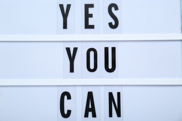 Lightbox with phrase Yes You Can, closeup. Motivational quote