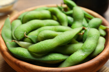 Bowl with green edamame beans in pods, closeup