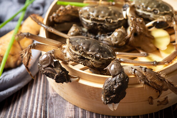 live hairy crab or mitten crab in steamer on table. © zhikun sun