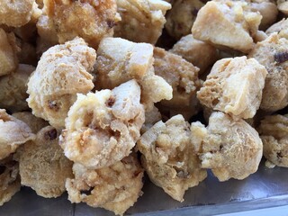 pile of crispy fried tofu at a street food vendor's stall