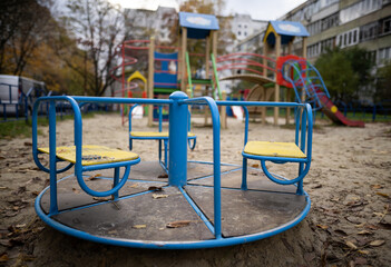 a lonely empty swing on a playground without people.