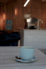 Coffee cup with blur coffee machine and bar background