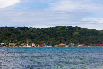 Beautiful beach of Isla Grande in Colon, Panama, colorful houses and blue sky and sea