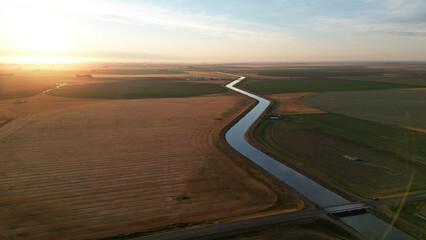 Drone view during sunrise over a farm hay field and river in Alberta Canada © WeWander