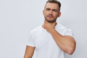 Man sore throat and cough, cold and flu, allergies, pain, in white t-shirt on white isolated background, copy space