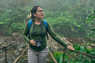 woman photographer on a suspension bridge