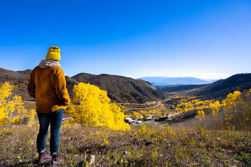 young woman looking at the autumn view bellow
