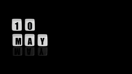 May 10th. Day 10 of month, Calendar date. White cubes with text on black background with reflection.Spring month, day of year concept