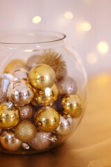 Close-up of golden glittery decorative Christmas glitters inside transparent glass jar