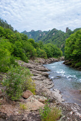 Fototapeta na wymiar mountain river, sources in the canyon of the stone bed, panorama of the area, rocky shores and the bottom of the riverbed