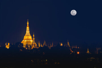 landscape scenery of Shwedagon pagoda on hill at fullmoon night famous sacred place and tourist attraction in Yangon Myanmar - Powered by Adobe