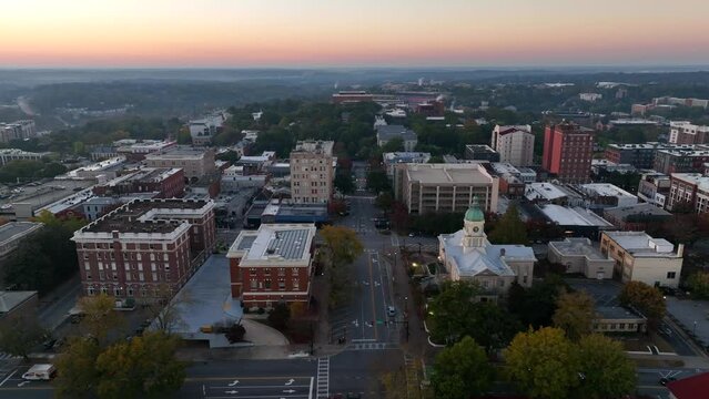Aerial establishing shot of Athens Georgia in early dawn hours. Truck shot.