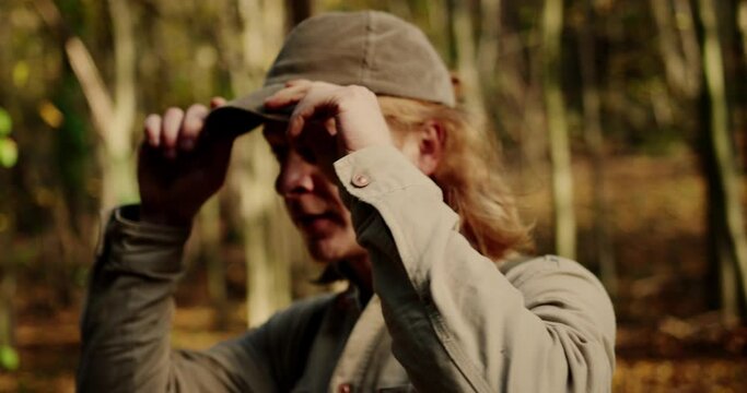 Medium Closed Up Shot Of Hiker Unbuttons His Shirt And Arranging His Blond Hair, Dürnstein