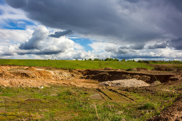 Quarry pit dug in the middle of a green landscape for stone extraction